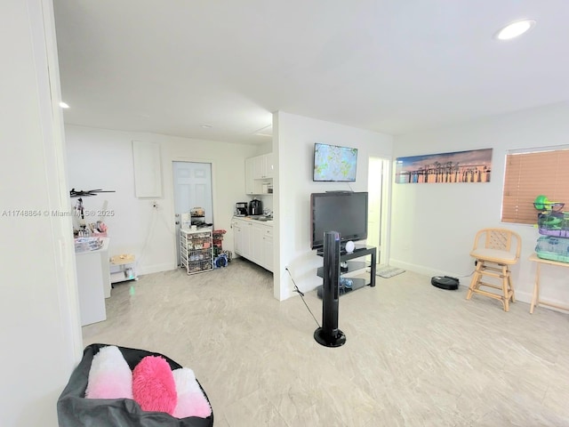 living room with washer / dryer, recessed lighting, and baseboards