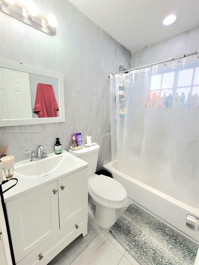 bathroom featuring toilet, tile walls, vanity, tasteful backsplash, and shower / bathtub combination with curtain