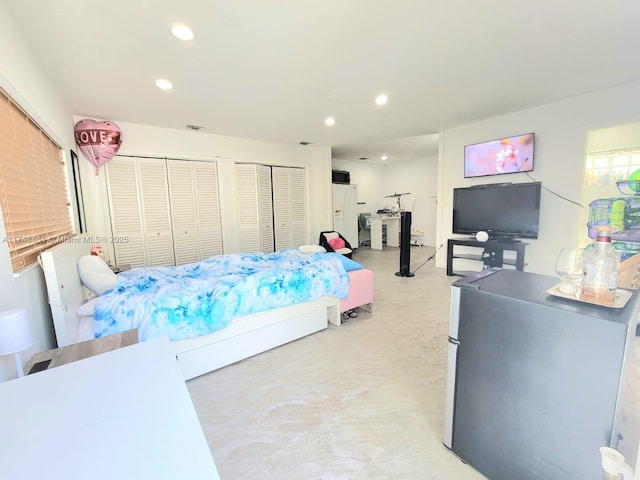 bedroom with white fridge with ice dispenser, multiple closets, freestanding refrigerator, and recessed lighting