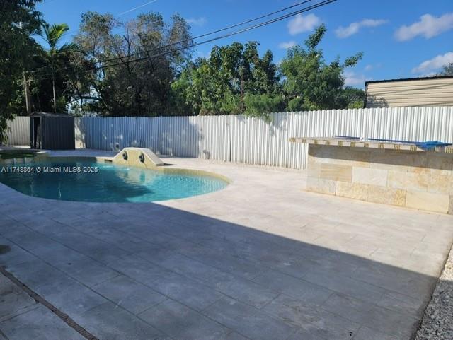 view of pool with a patio area, a fenced backyard, and a fenced in pool