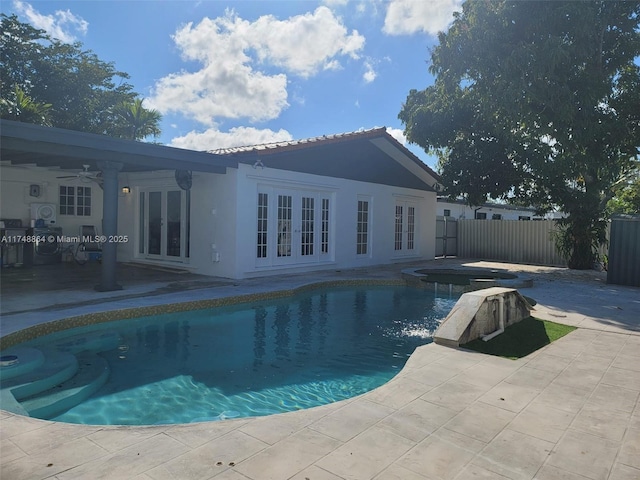 view of swimming pool with ceiling fan, a patio, fence, french doors, and a fenced in pool