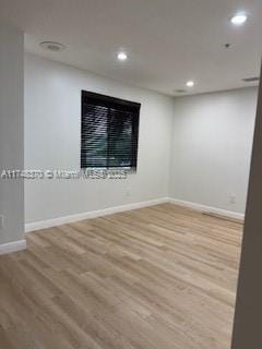 unfurnished room with baseboards, wood finished floors, and recessed lighting