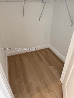 spacious closet with wood finished floors