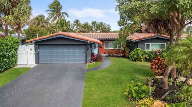 ranch-style house with aphalt driveway, a tile roof, stucco siding, a garage, and a front lawn