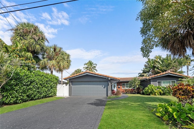 single story home with a garage, stucco siding, concrete driveway, and a front yard