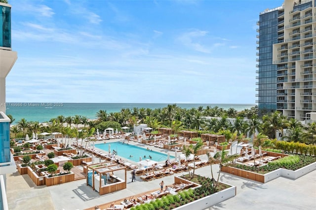 view of swimming pool featuring a water view