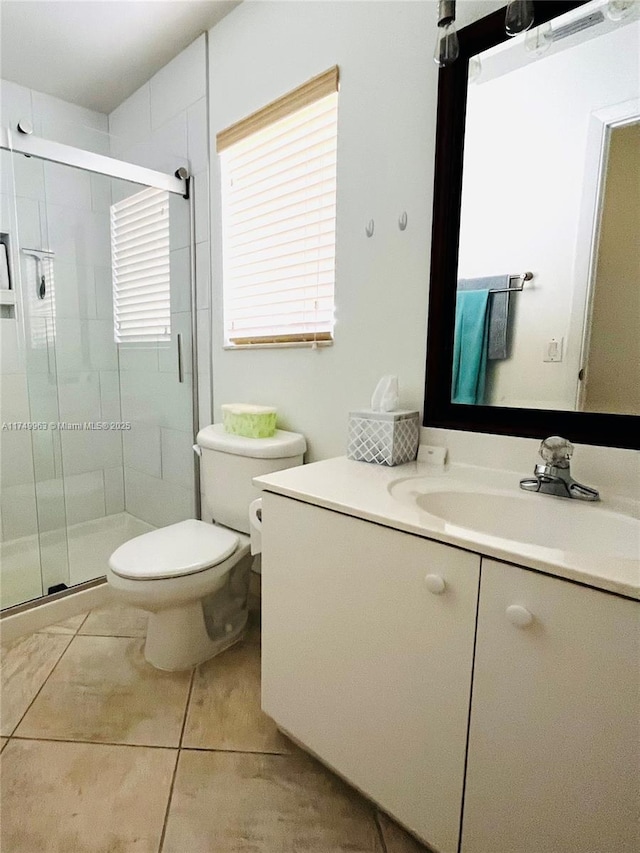 full bathroom featuring tile patterned flooring, a shower stall, vanity, and toilet