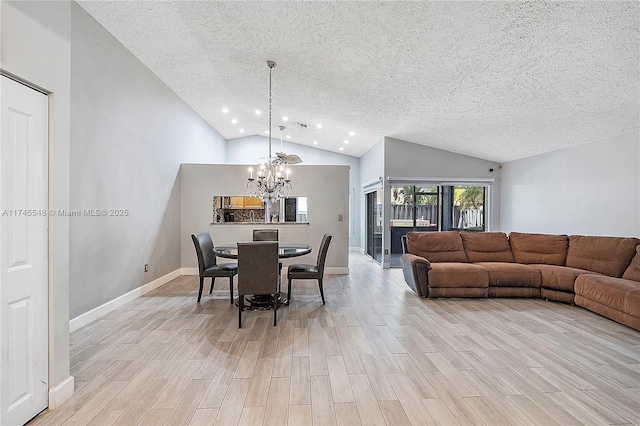 dining room featuring a chandelier, a textured ceiling, and light wood-type flooring