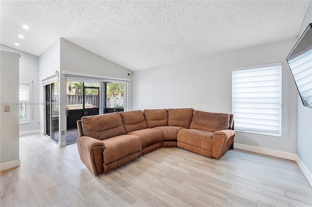 living room featuring a textured ceiling, recessed lighting, baseboards, vaulted ceiling, and light wood finished floors