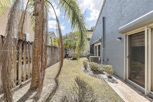 view of yard featuring a fenced backyard and central AC unit