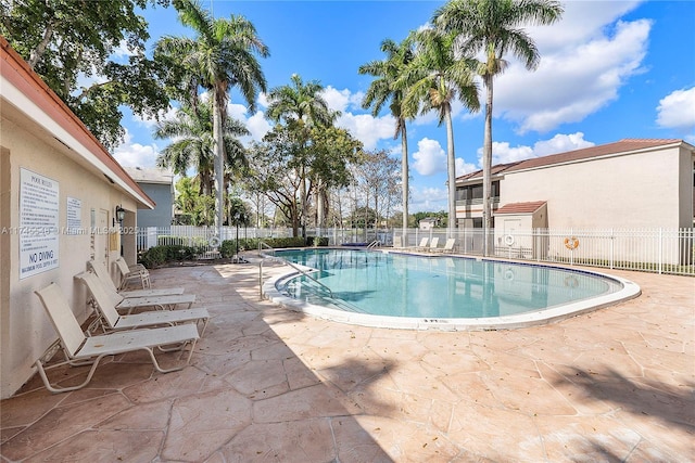 pool featuring a patio area and fence