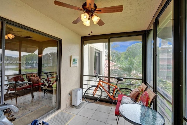 sunroom featuring a ceiling fan