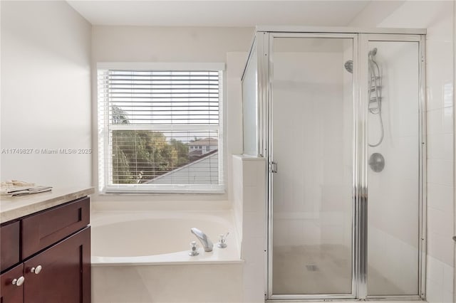 bathroom with a garden tub, a shower stall, and vanity