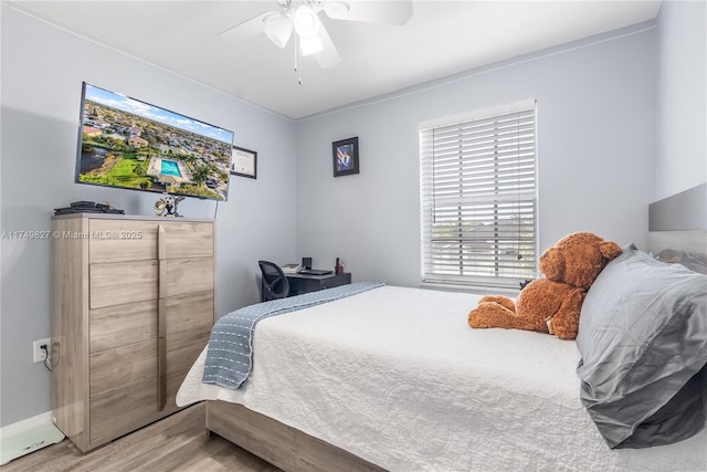 bedroom featuring ceiling fan and wood finished floors