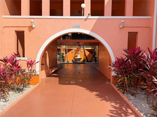 doorway to property featuring stucco siding