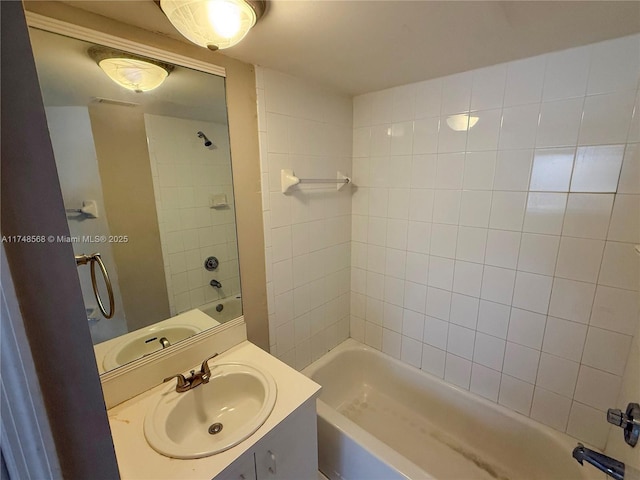 bathroom with washtub / shower combination and vanity