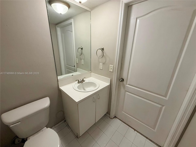 bathroom featuring toilet, tile patterned flooring, and vanity