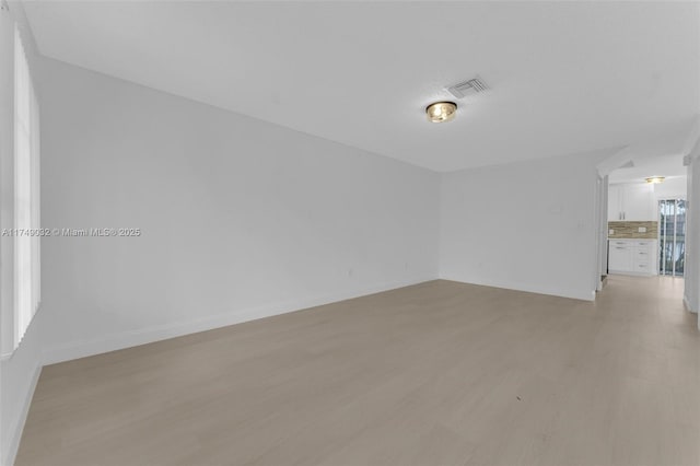 9745 NW 37th St Unit 9745, Sunrise, FL 33351 - empty room with visible vents, light wood finished floors, and baseboards