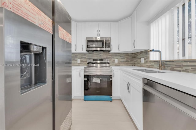 9745 NW 37th St Unit 9745, Sunrise, FL 33351 - kitchen with a sink, light countertops, stainless steel appliances, and white cabinetry