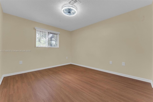 9745 NW 37th St Unit 9745, Sunrise, FL 33351 - empty room featuring baseboards, a textured ceiling, and wood finished floors