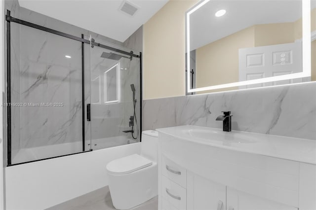 9745 NW 37th St Unit 9745, Sunrise, FL 33351 - full bathroom with visible vents, vanity, toilet, tile walls, and bath / shower combo with glass door