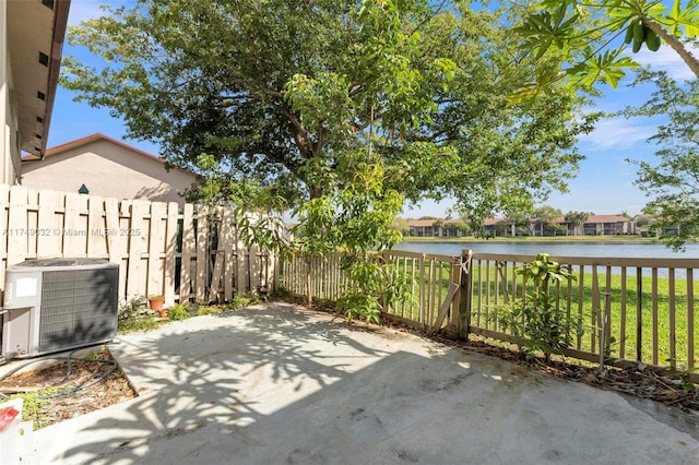 9745 NW 37th St Unit 9745, Sunrise, FL 33351 - view of patio / terrace with central air condition unit, fence, and a water view