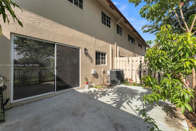 9745 NW 37th St Unit 9745, Sunrise, FL 33351 - back of house with fence, a patio, stucco siding, and central AC
