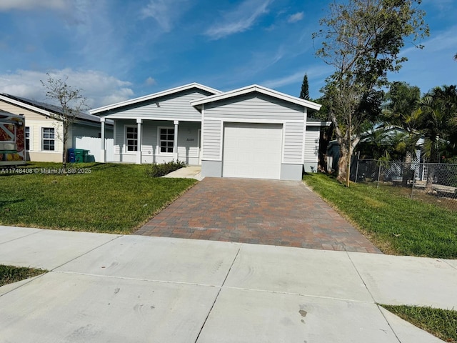 view of front of property with a garage, a front yard, decorative driveway, and fence