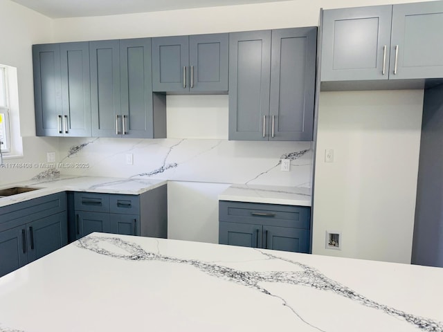 kitchen with light stone counters and decorative backsplash