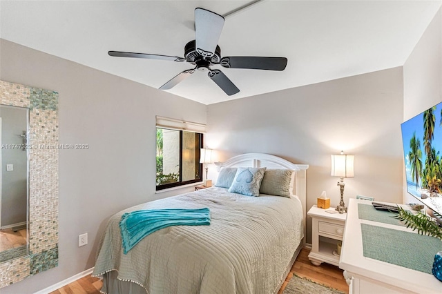 bedroom with ceiling fan, light wood-type flooring, and baseboards