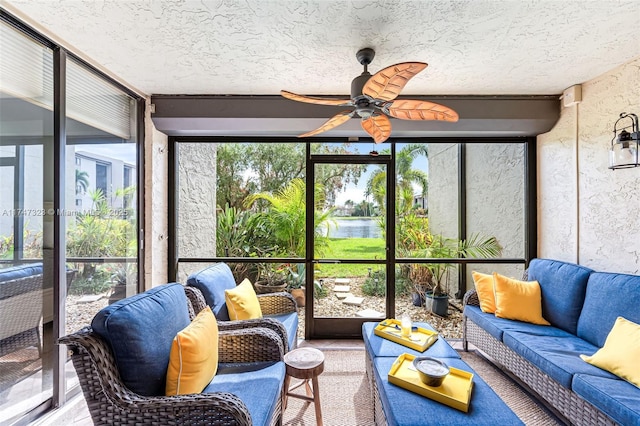 sunroom / solarium featuring a ceiling fan