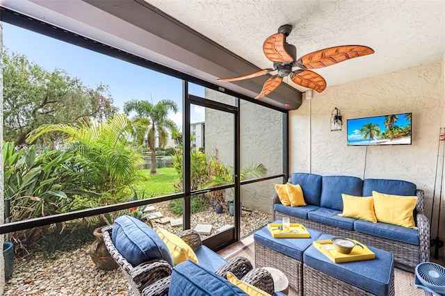 sunroom / solarium featuring a ceiling fan