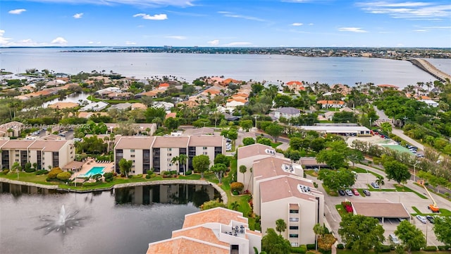 drone / aerial view with a residential view and a water view