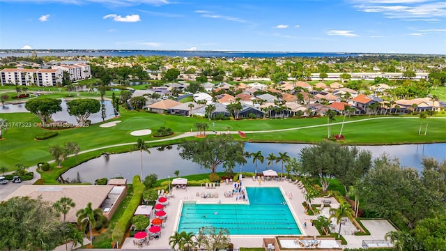 drone / aerial view with a water view and golf course view