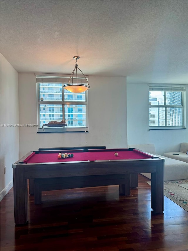 recreation room with pool table, wood finished floors, baseboards, and a textured ceiling