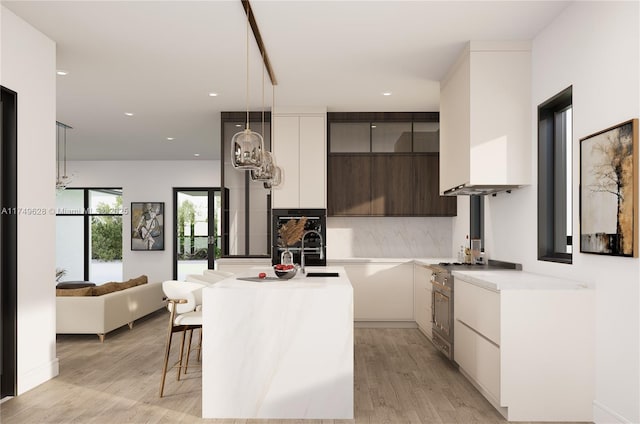 702 NW 5th Ave, Delray Beach, FL 33444 - kitchen with modern cabinets, light wood finished floors, light countertops, high end stainless steel range oven, and recessed lighting