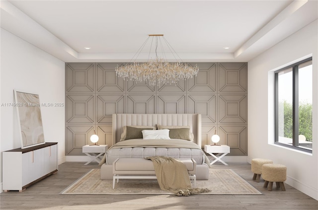 702 NW 5th Ave, Delray Beach, FL 33444 - bedroom featuring an accent wall, baseboards, a chandelier, recessed lighting, and a raised ceiling