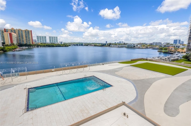 view of pool with a view of city, a patio, and a water view