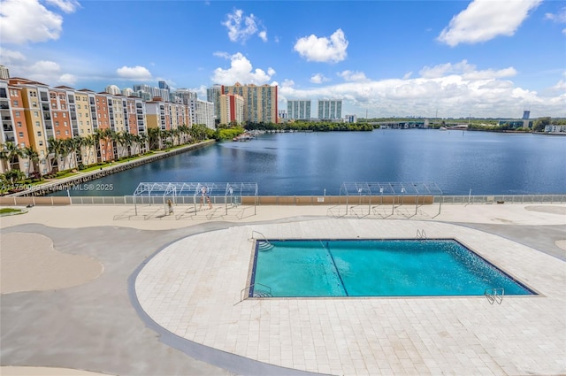 pool with a patio and a water view