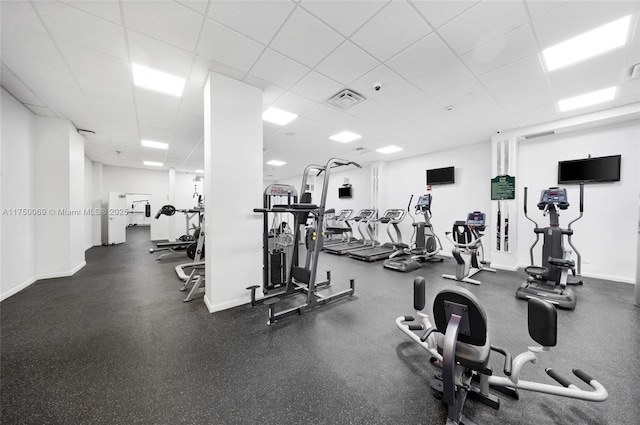 gym featuring baseboards, visible vents, and a drop ceiling