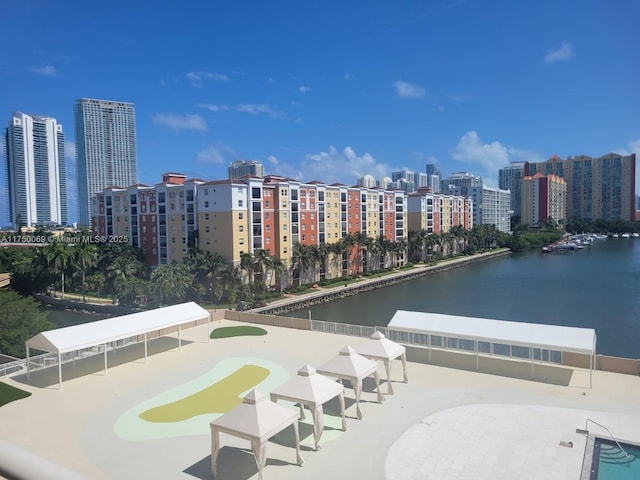 exterior space with a city view and a water view