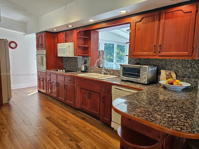 kitchen with a toaster, open shelves, dark wood-type flooring, a sink, and white appliances