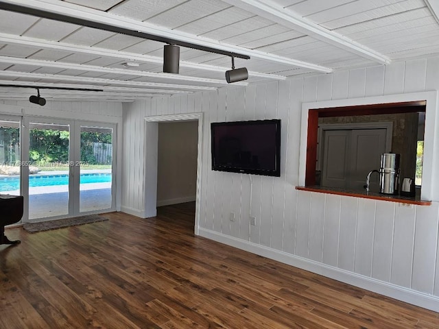 unfurnished living room featuring baseboards and wood finished floors