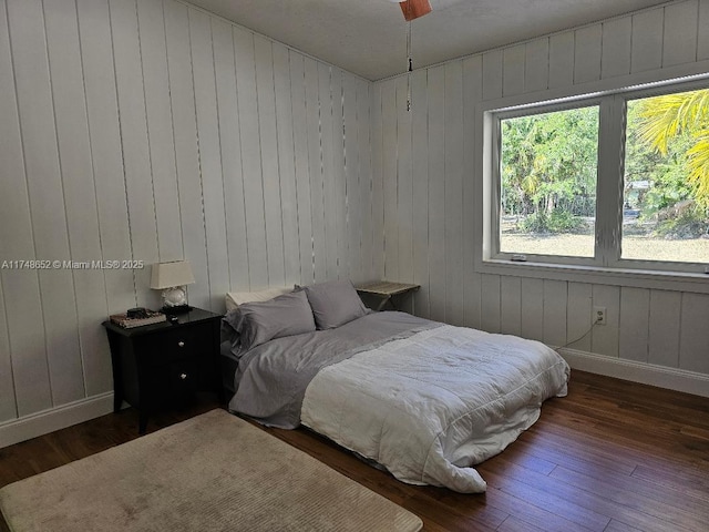 bedroom with baseboards and wood finished floors