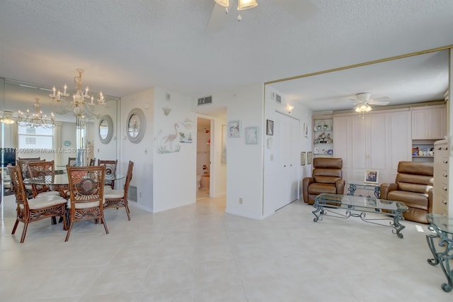 1505 N Riverside Dr Unit 604, Pompano Beach, FL 33062 - dining space with ceiling fan, a textured ceiling, a chandelier, light tile patterned floors, and baseboards