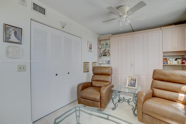 1505 N Riverside Dr Unit 604, Pompano Beach, FL 33062 - sitting room featuring a ceiling fan, light tile patterned flooring, and a textured ceiling