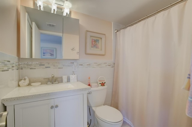 1505 N Riverside Dr Unit 604, Pompano Beach, FL 33062 - full bath with toilet, vanity, tile walls, and a wainscoted wall