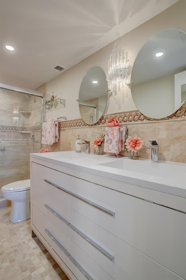 1505 N Riverside Dr Unit 604, Pompano Beach, FL 33062 - full bathroom featuring tile walls, vanity, a shower stall, recessed lighting, and toilet
