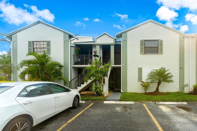 exterior space with uncovered parking and stairway