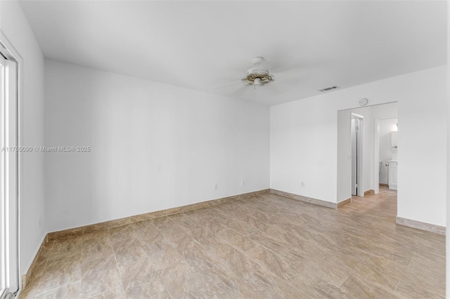 unfurnished room featuring visible vents, baseboards, and ceiling fan